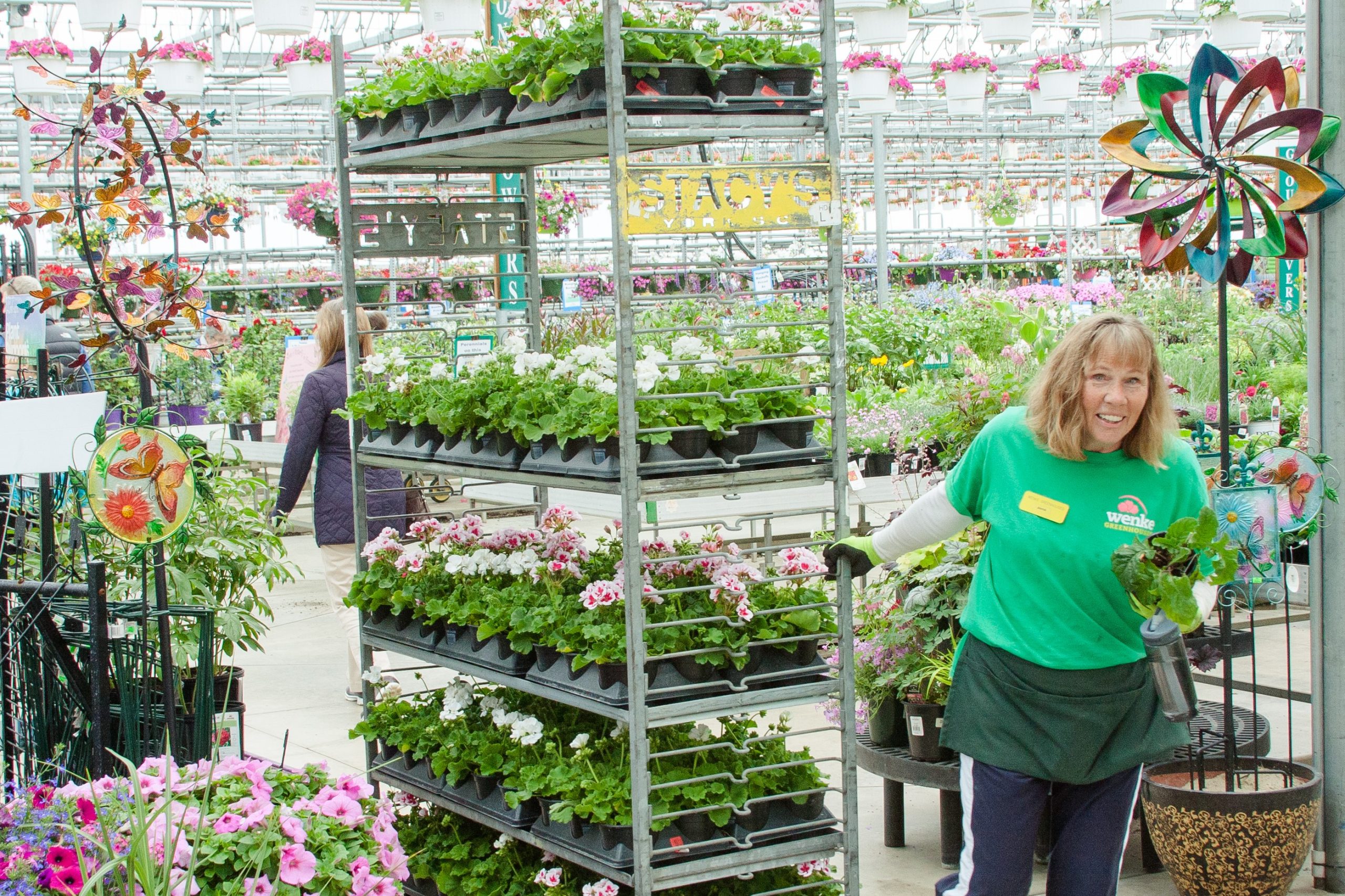 person pulling cart filled with plants
