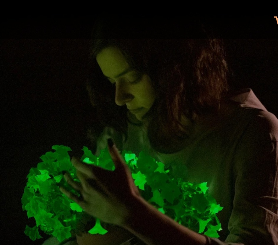 woman holding glow in the dark plant